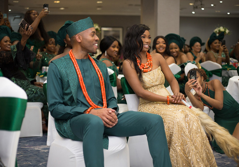 Bride and groom smile as they watch the dancefloor